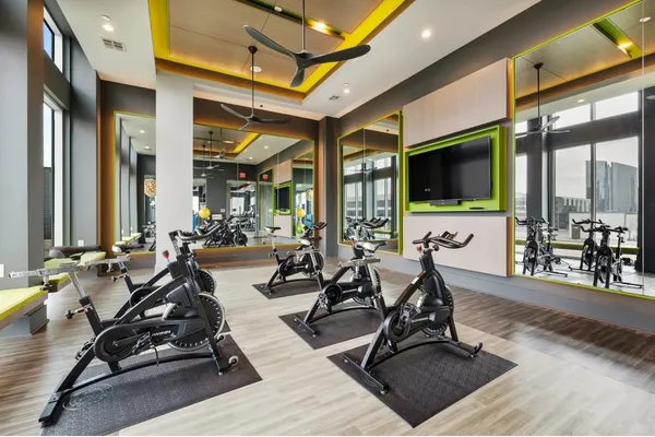 a living room with patio furniture and a flat screen tv
