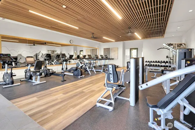 a view of a room with wooden floor and windows