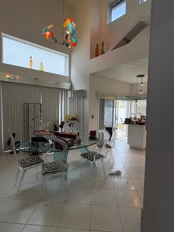 a living room with furniture a dining table and chairs