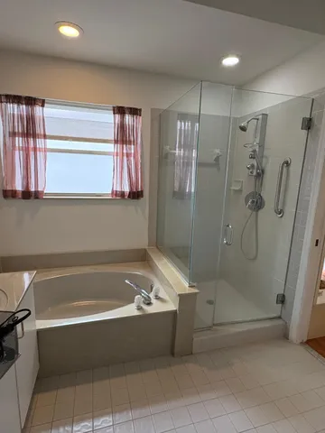 a bathroom with a bathtub and a shower
