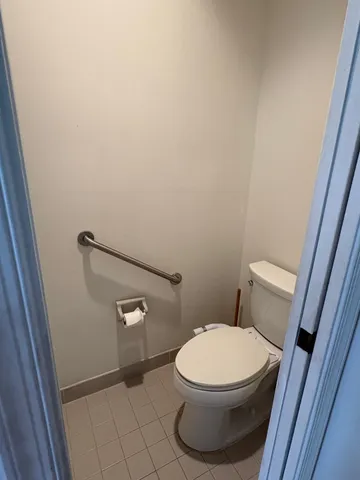 a white toilet sitting next to a shower