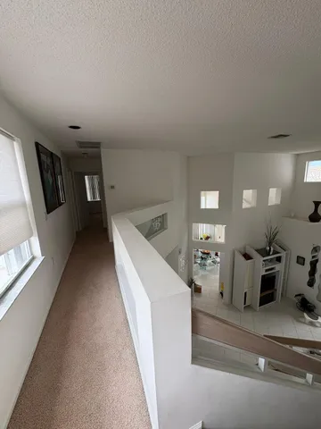 a view of a hallway with seating space