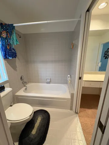 a bathroom with a toilet a sink and bathtub