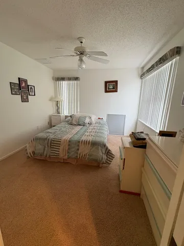 a bedroom with a bed and a dresser in it