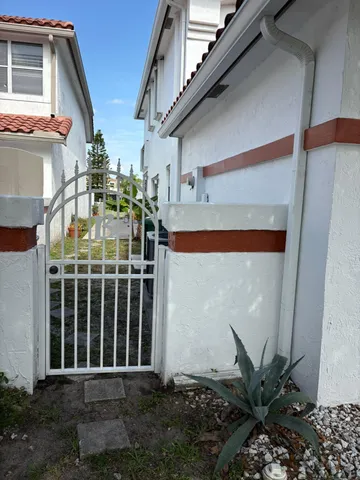 a front view of a house with plants