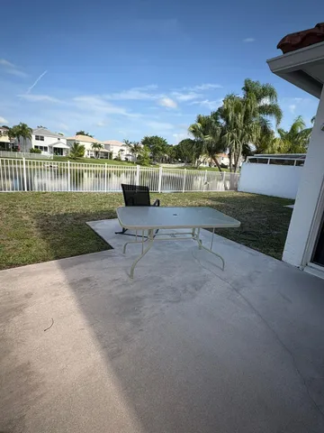 a view of a yard with table and chairs