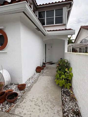 a vase of flowers sitting on a floor