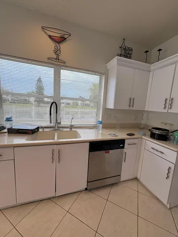 a kitchen with stainless steel appliances granite countertop a sink and a stove