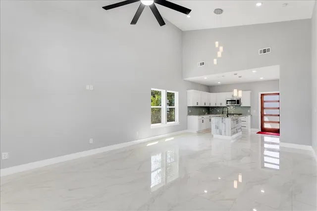 a kitchen with stainless steel appliances granite countertop a sink stove and cabinets