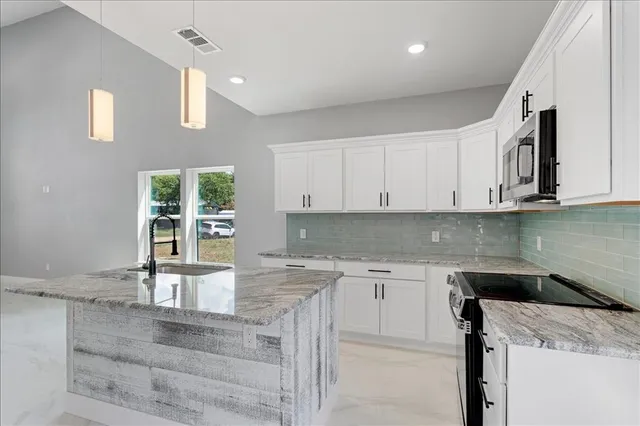 a kitchen with a stove and microwave