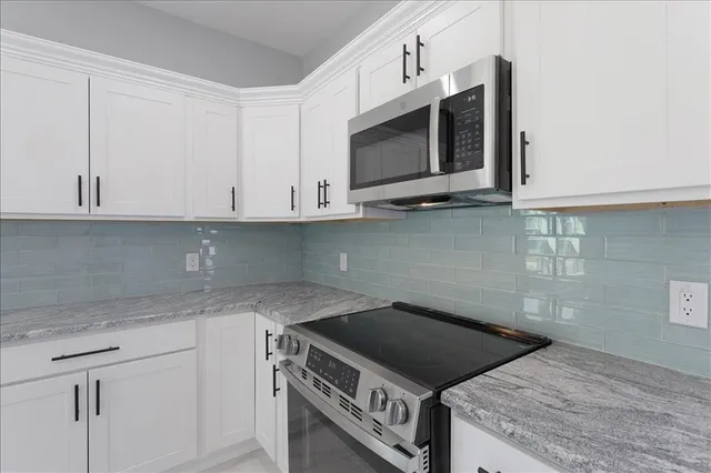 a bathroom with a granite countertop sink a toilet and a mirror