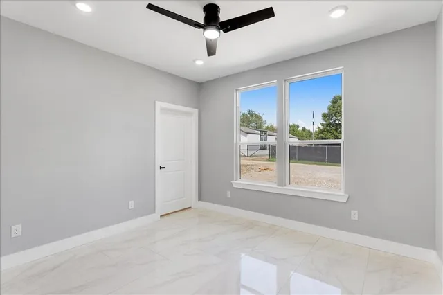 a bathroom with a granite countertop sink a toilet and shower