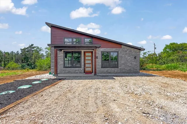 a front view of a house with garden