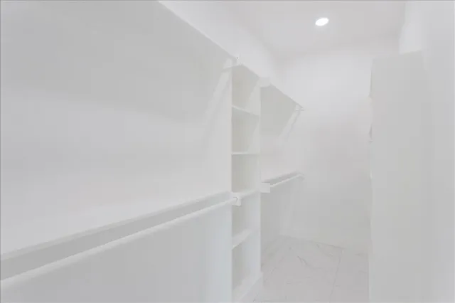 an empty room with ceiling fan