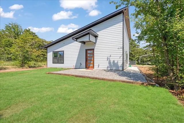 an aerial view of a house with yard swimming pool and outdoor seating