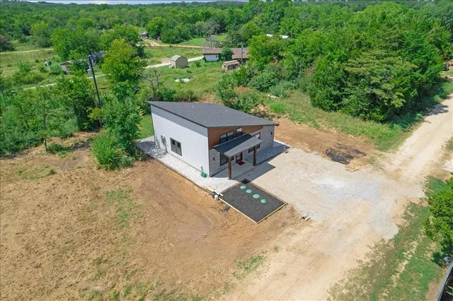 an aerial view of a house with a yard