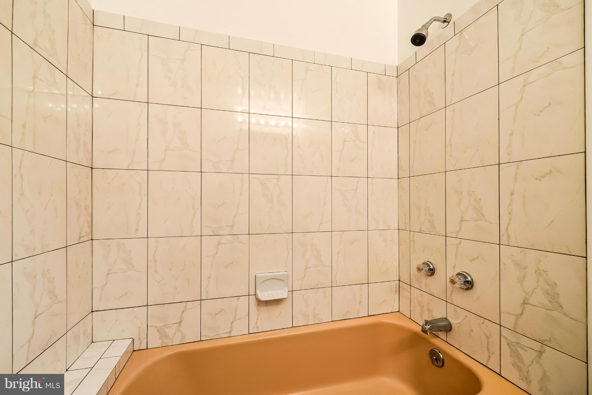 3918 Elby Street Silver Spring, MD 20906 - Photo 14 of 23 a bathroom with a bathtub and shower