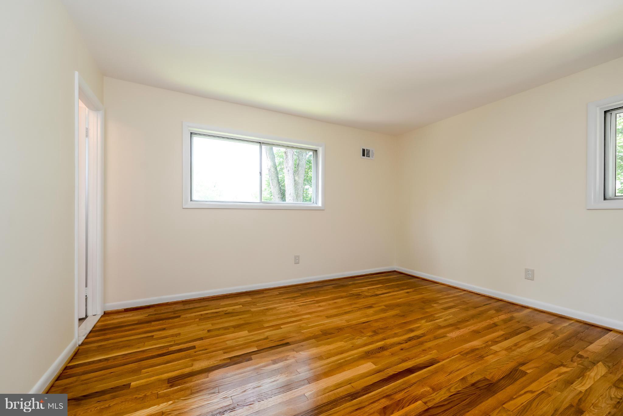 3918 Elby Street Silver Spring, MD 20906 - Photo 16 of 23 a view of an empty room with wooden floor and a window