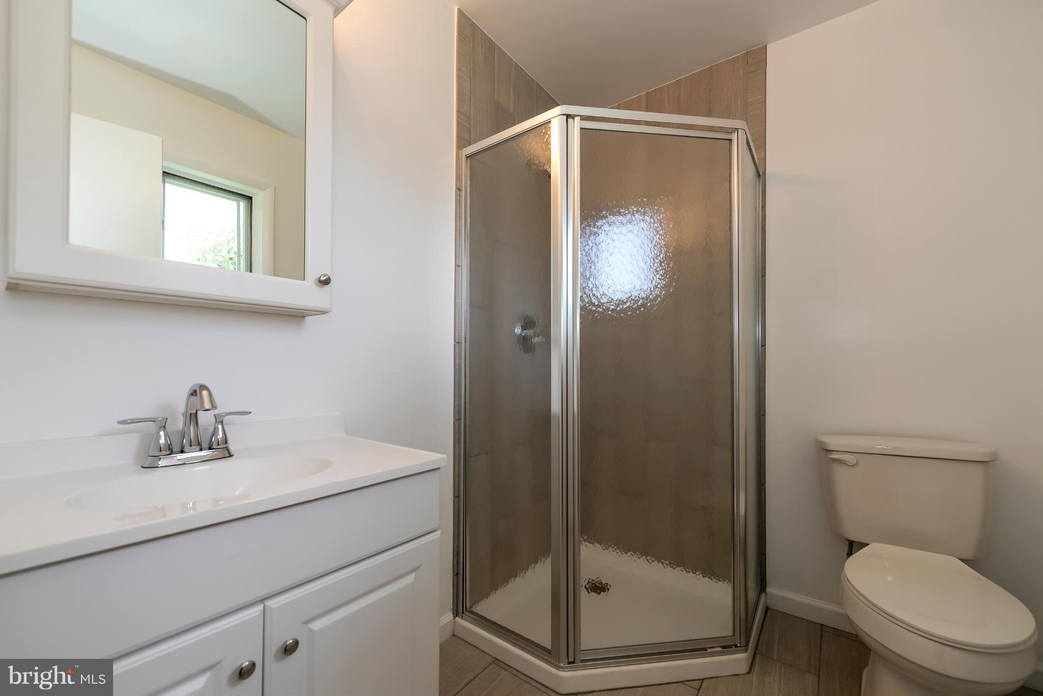3918 Elby Street Silver Spring, MD 20906 - Photo 17 of 23 a bathroom with a sink a toilet and shower