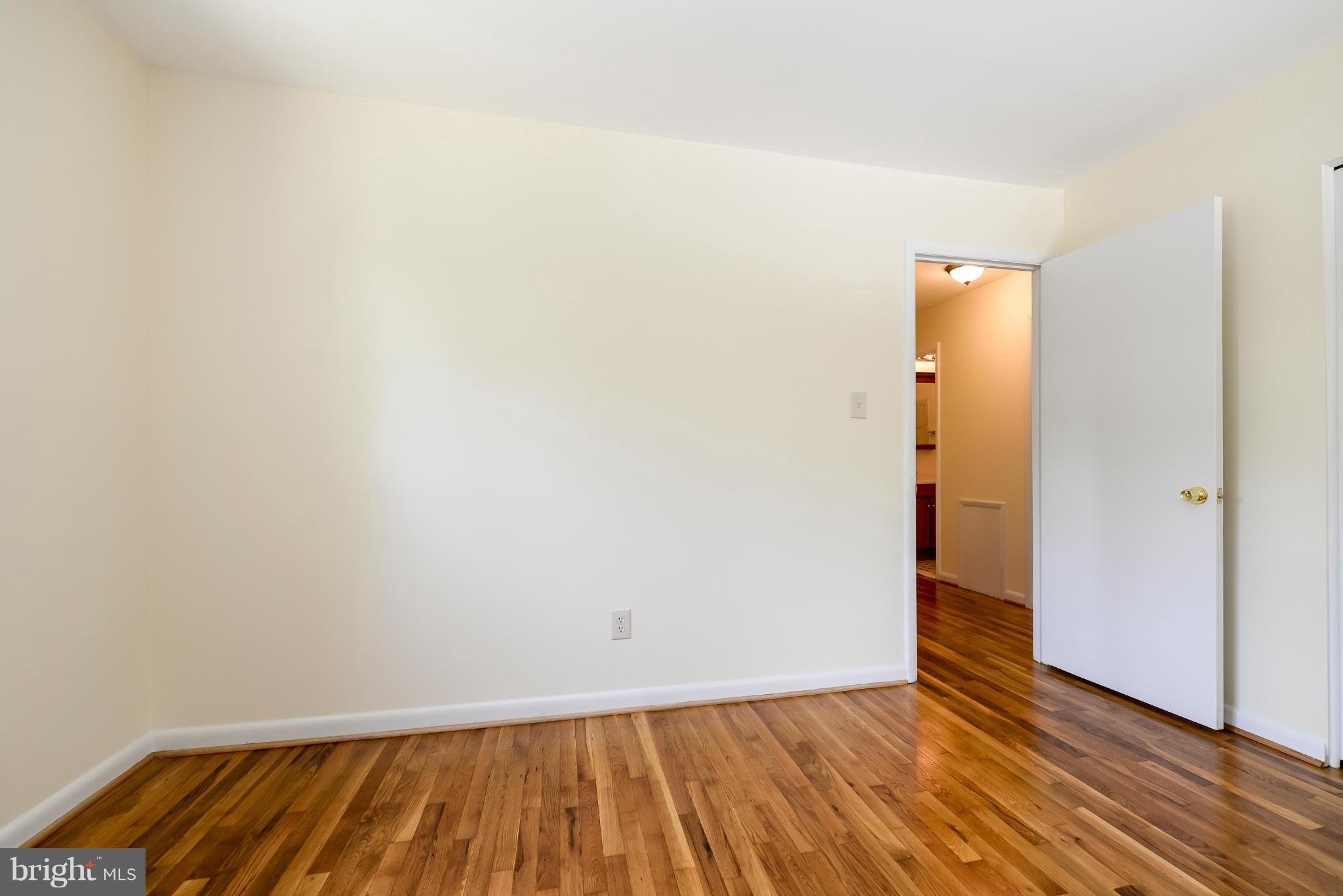 3918 Elby Street Silver Spring, MD 20906 - Photo 18 of 23 a view of an empty room with wooden floor