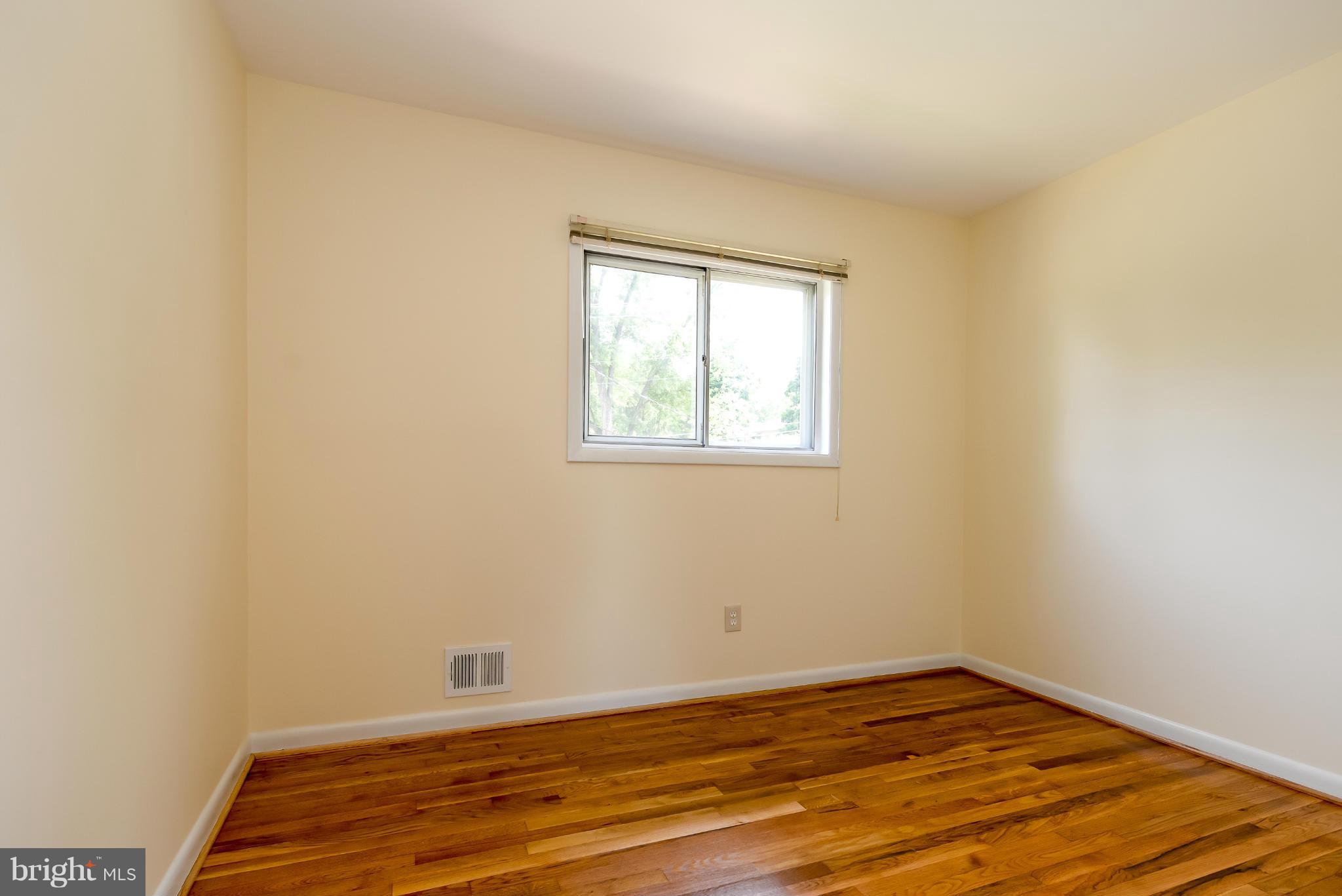 3918 Elby Street Silver Spring, MD 20906 - Photo 21 of 23 an empty room with wooden floor and windows