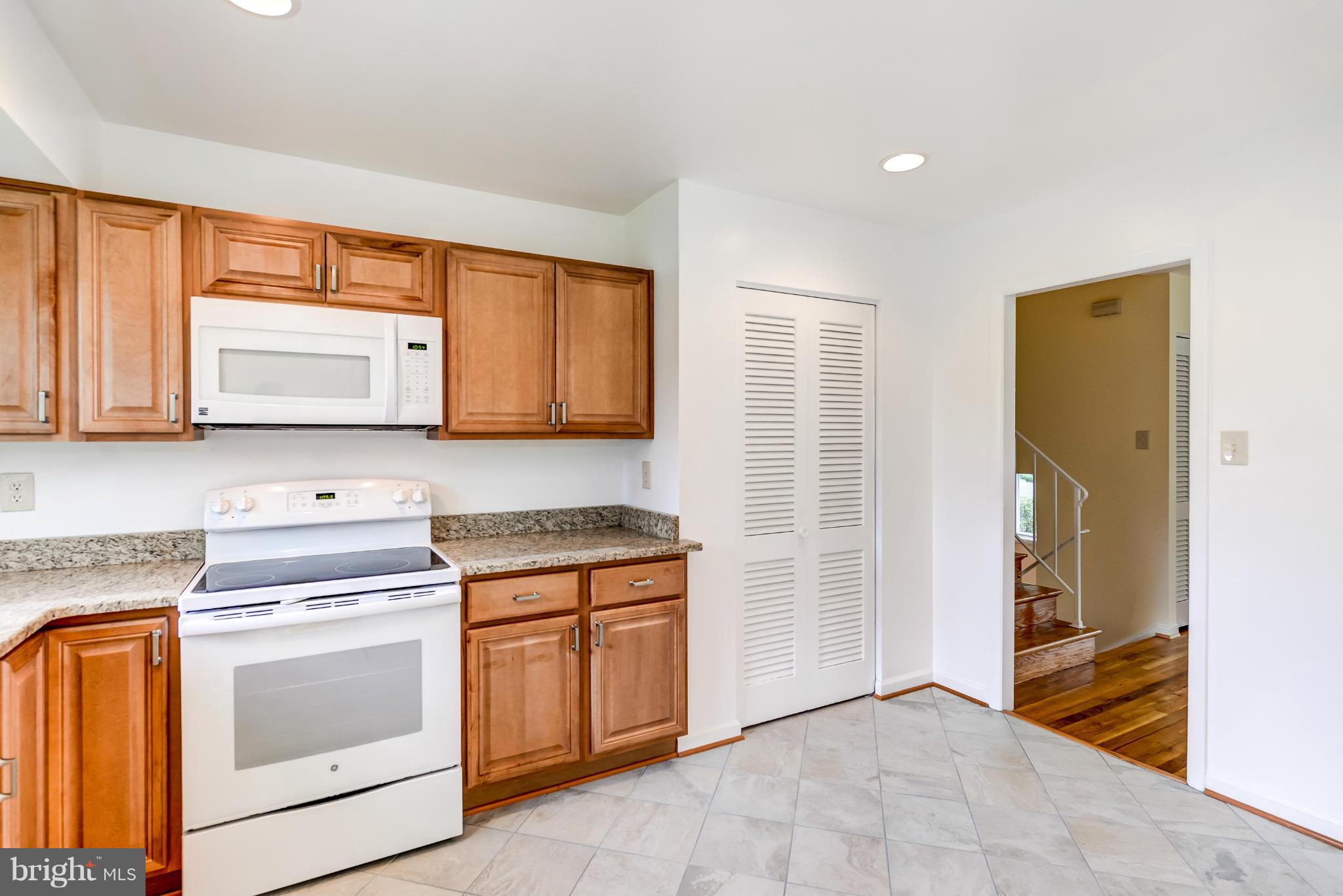 3918 Elby Street Silver Spring, MD 20906 - Photo 6 of 23 a kitchen with stainless steel appliances granite countertop a stove and a microwave oven