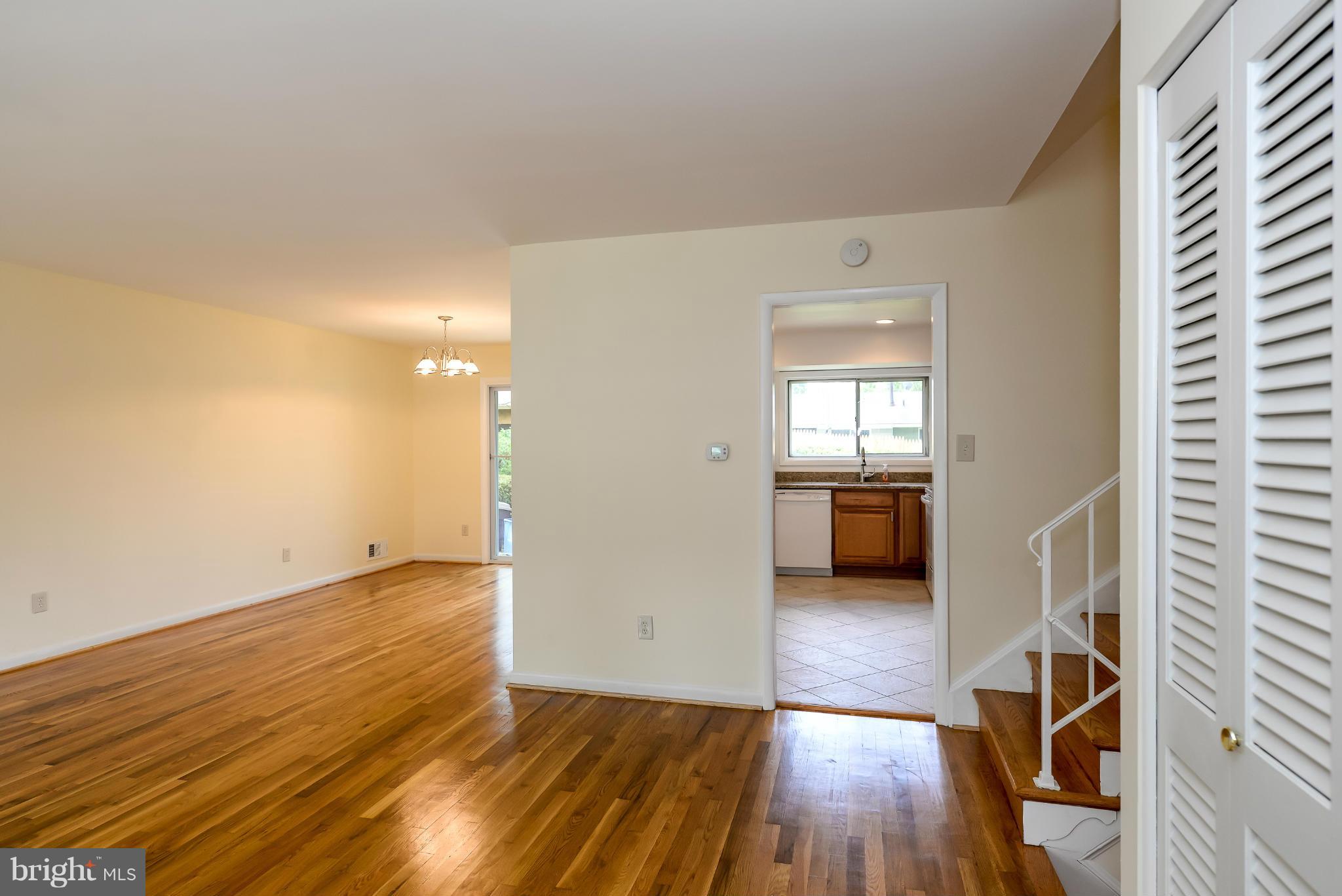 3918 Elby Street Silver Spring, MD 20906 - Photo 7 of 23 a view of a hallway with wooden floor and a bathroom