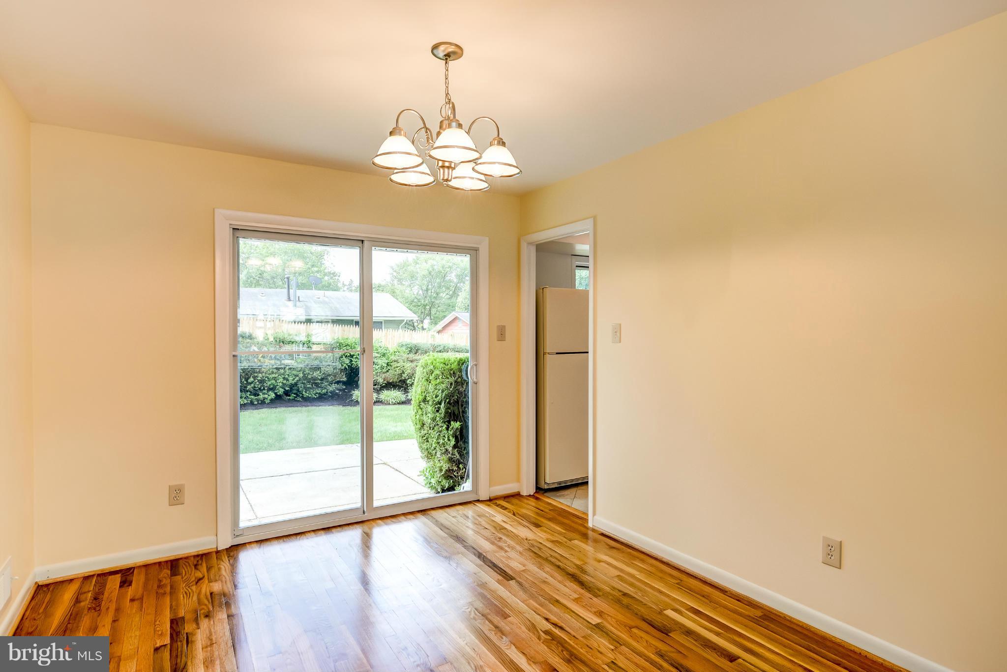 3918 Elby Street Silver Spring, MD 20906 - Photo 8 of 23 a view of an empty room with wooden floor and a window