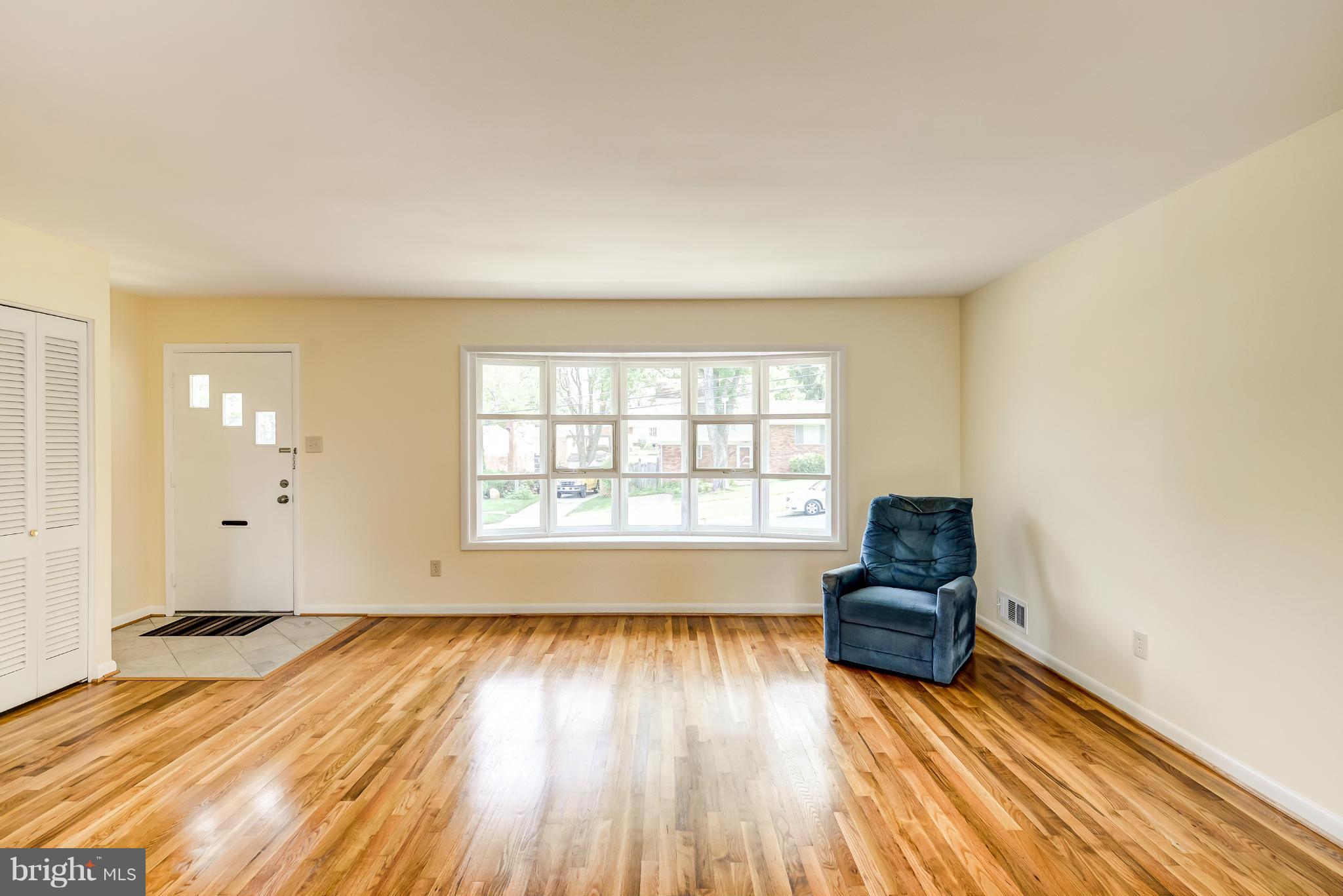 3918 Elby Street Silver Spring, MD 20906 - Photo 9 of 23 an empty room with wooden floor and windows