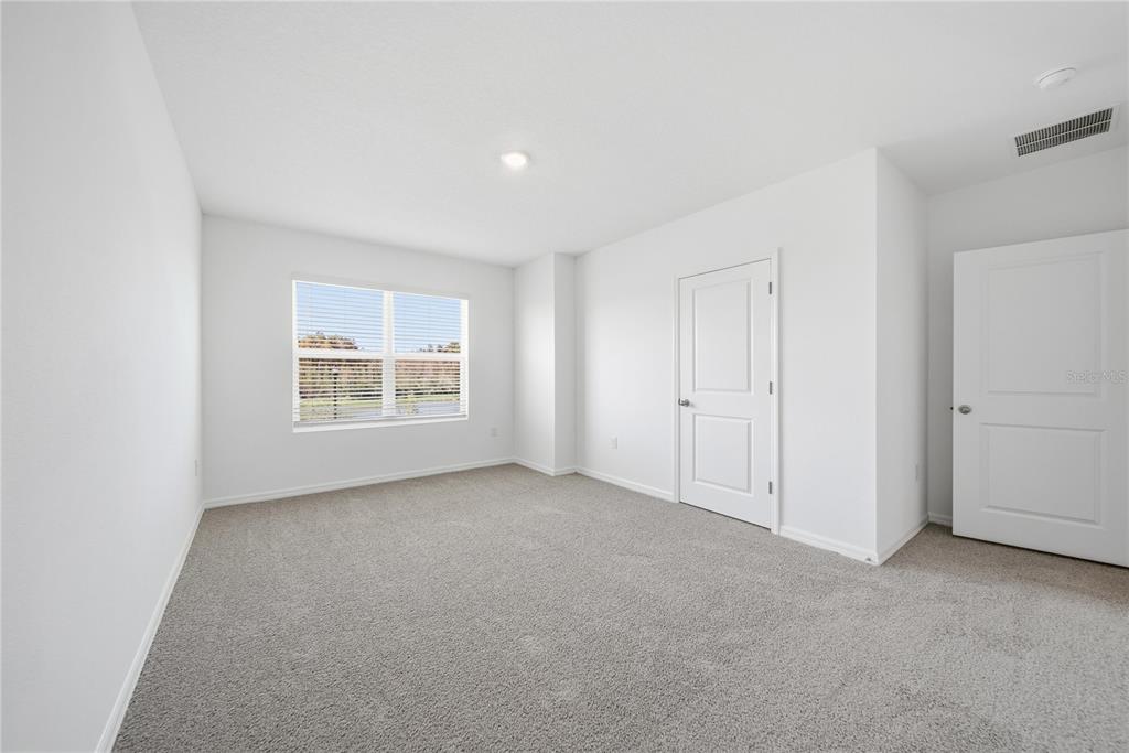 2480 Riversong Ldg Lane Wesley Chapel, FL 33543 - Photo 15 of 30 an empty room with windows