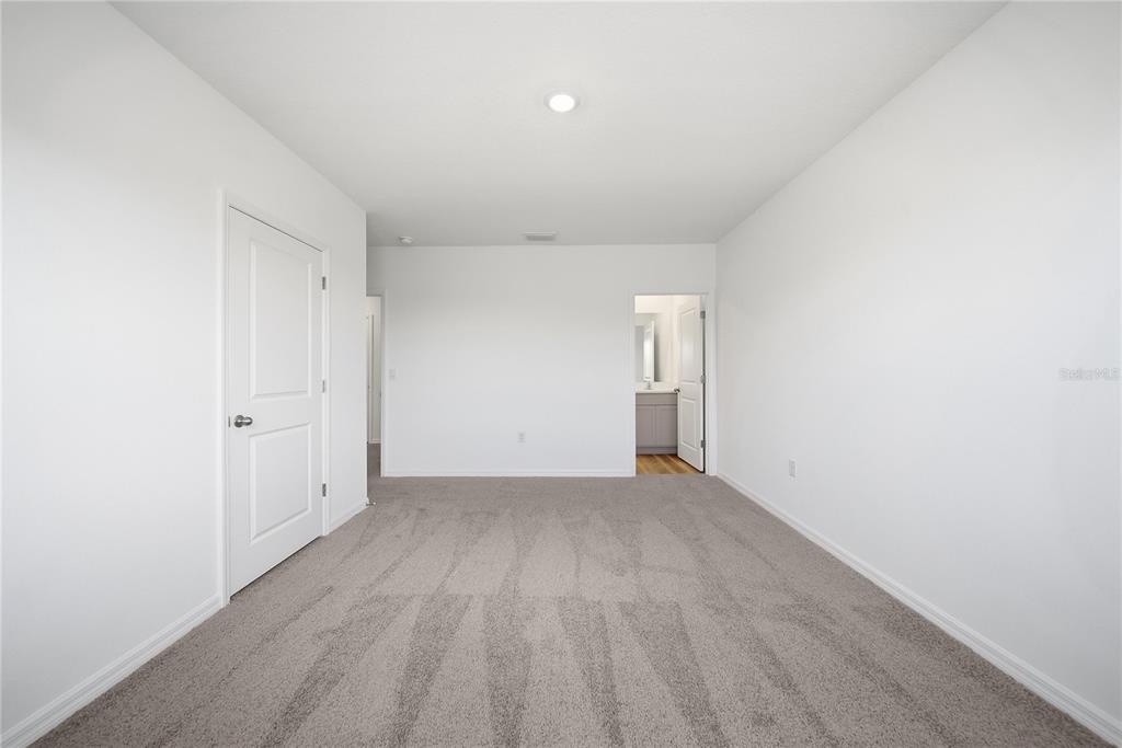 2480 Riversong Ldg Lane Wesley Chapel, FL 33543 - Photo 16 of 30 a view of an empty room and wooden floor