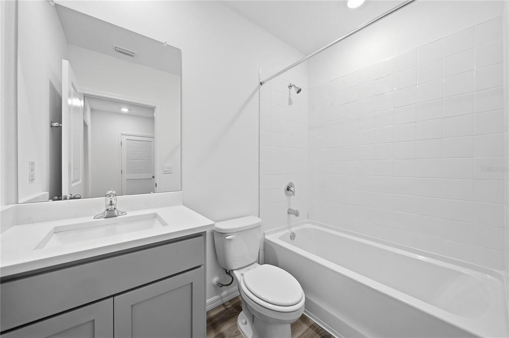 2480 Riversong Ldg Lane Wesley Chapel, FL 33543 - Photo 18 of 30 a bathroom with a sink toilet vanity and shower