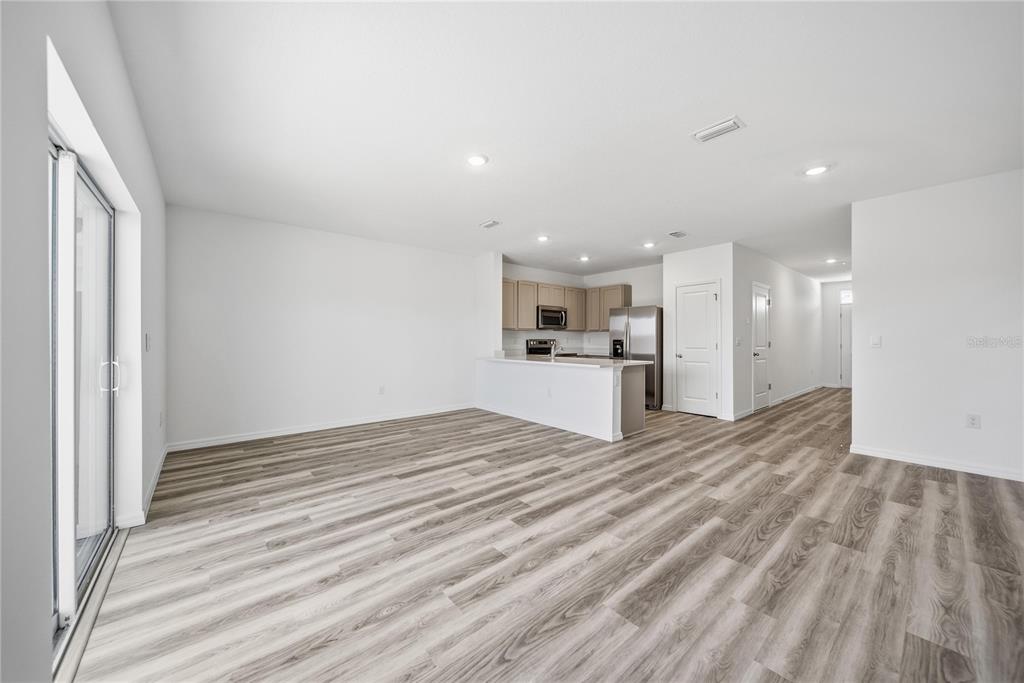 2480 Riversong Ldg Lane Wesley Chapel, FL 33543 - Photo 3 of 30 a view of empty room with kitchen and window