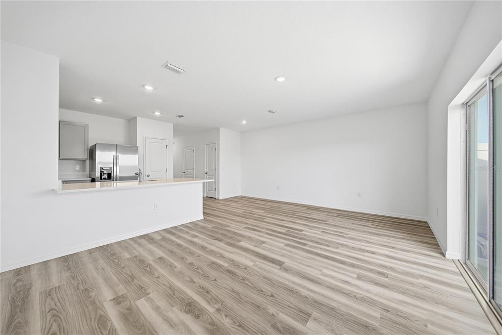 2480 Riversong Ldg Lane Wesley Chapel, FL 33543 - Photo 4 of 30 a view of kitchen with kitchen island white cabinets and wooden floor