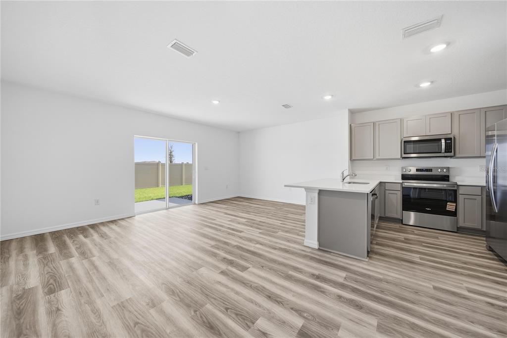 2480 Riversong Ldg Lane Wesley Chapel, FL 33543 - Photo 5 of 30 a view of a kitchen with microwave and cabinets