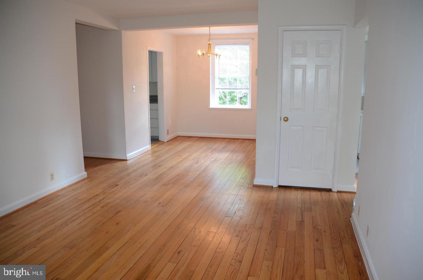 3880 Rodman Street Northwest, Unit C213 Washington, DC 20016 - Photo 4 of 32 an empty room with wooden floor and windows