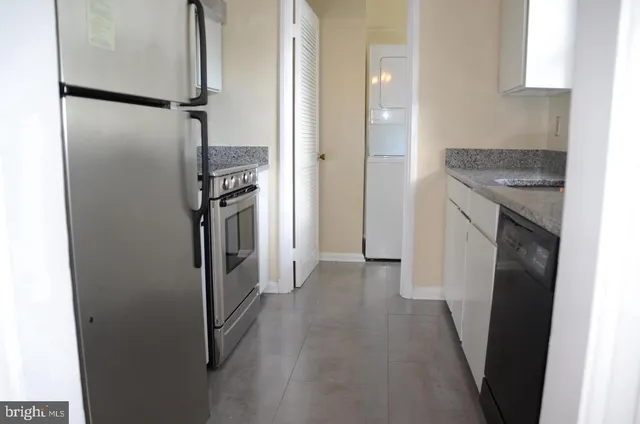 a kitchen with a refrigerator and a stove