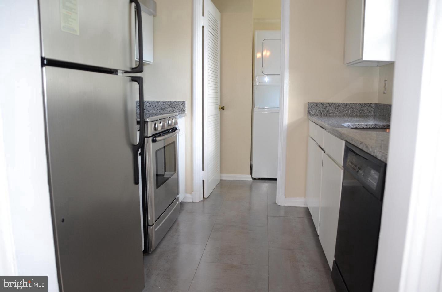 3880 Rodman Street Northwest, Unit C213 Washington, DC 20016 - Photo 5 of 32 a kitchen with a refrigerator and a stove