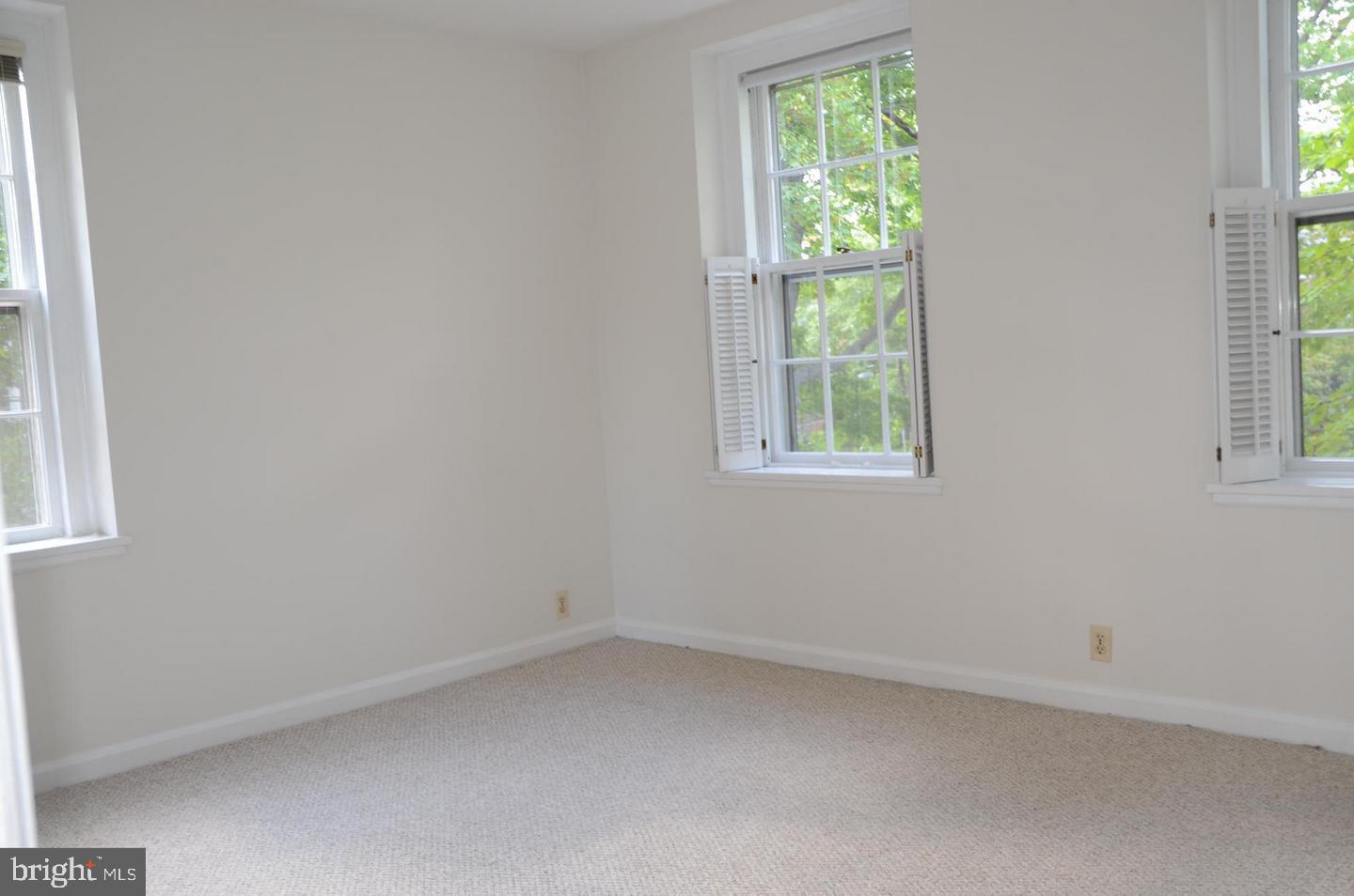 3880 Rodman Street Northwest, Unit C213 Washington, DC 20016 - Photo 7 of 32 an empty room with a window