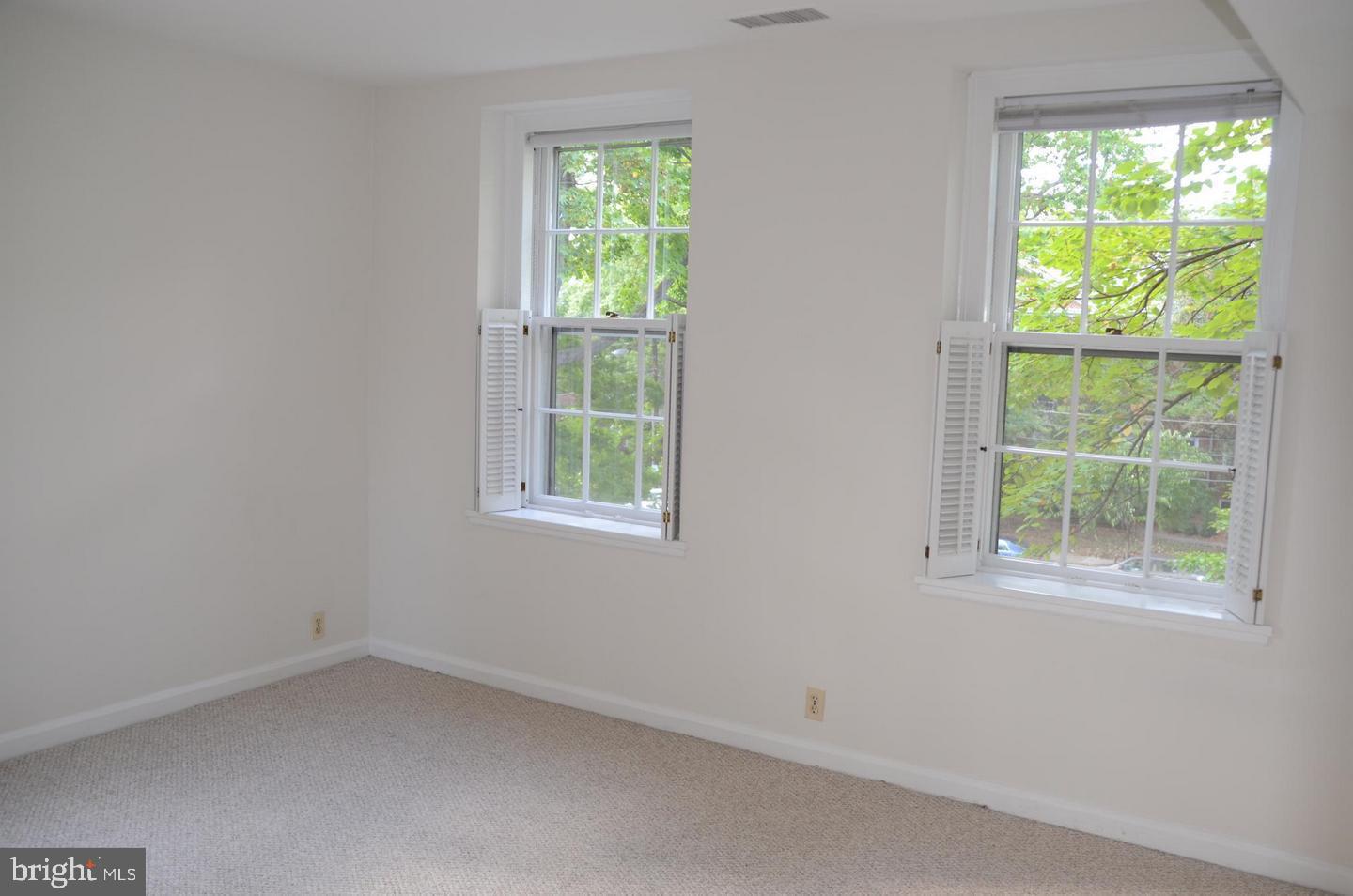 3880 Rodman Street Northwest, Unit C213 Washington, DC 20016 - Photo 8 of 32 an empty room with a window