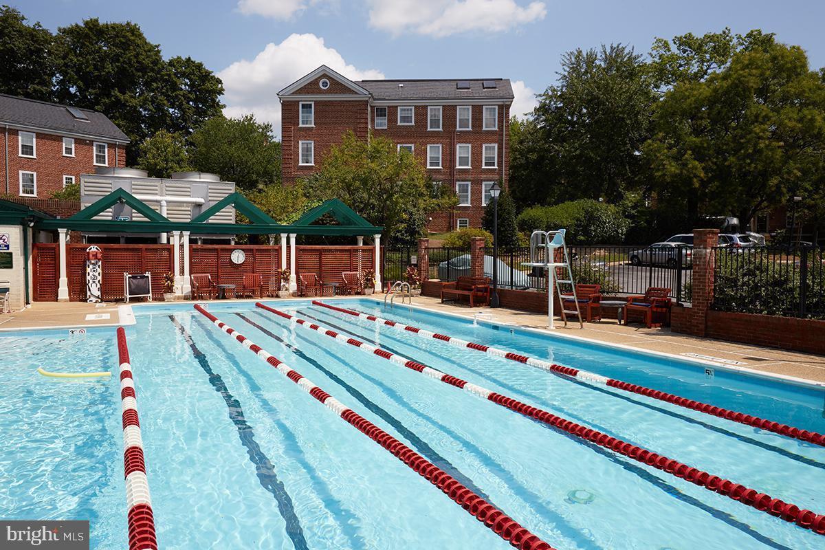 3880 Rodman Street Northwest, Unit C213 Washington, DC 20016 - Photo 9 of 32 a backyard of a house with table and chairs