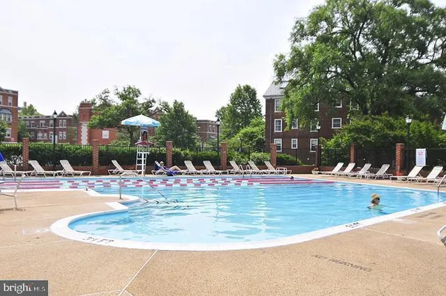 a view of a swimming pool with outdoor seating