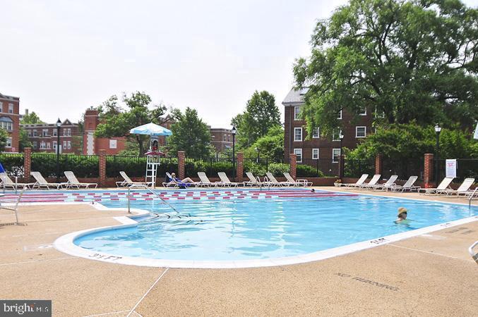 3880 Rodman Street Northwest, Unit C213 Washington, DC 20016 - Photo 10 of 32 a view of a swimming pool with outdoor seating
