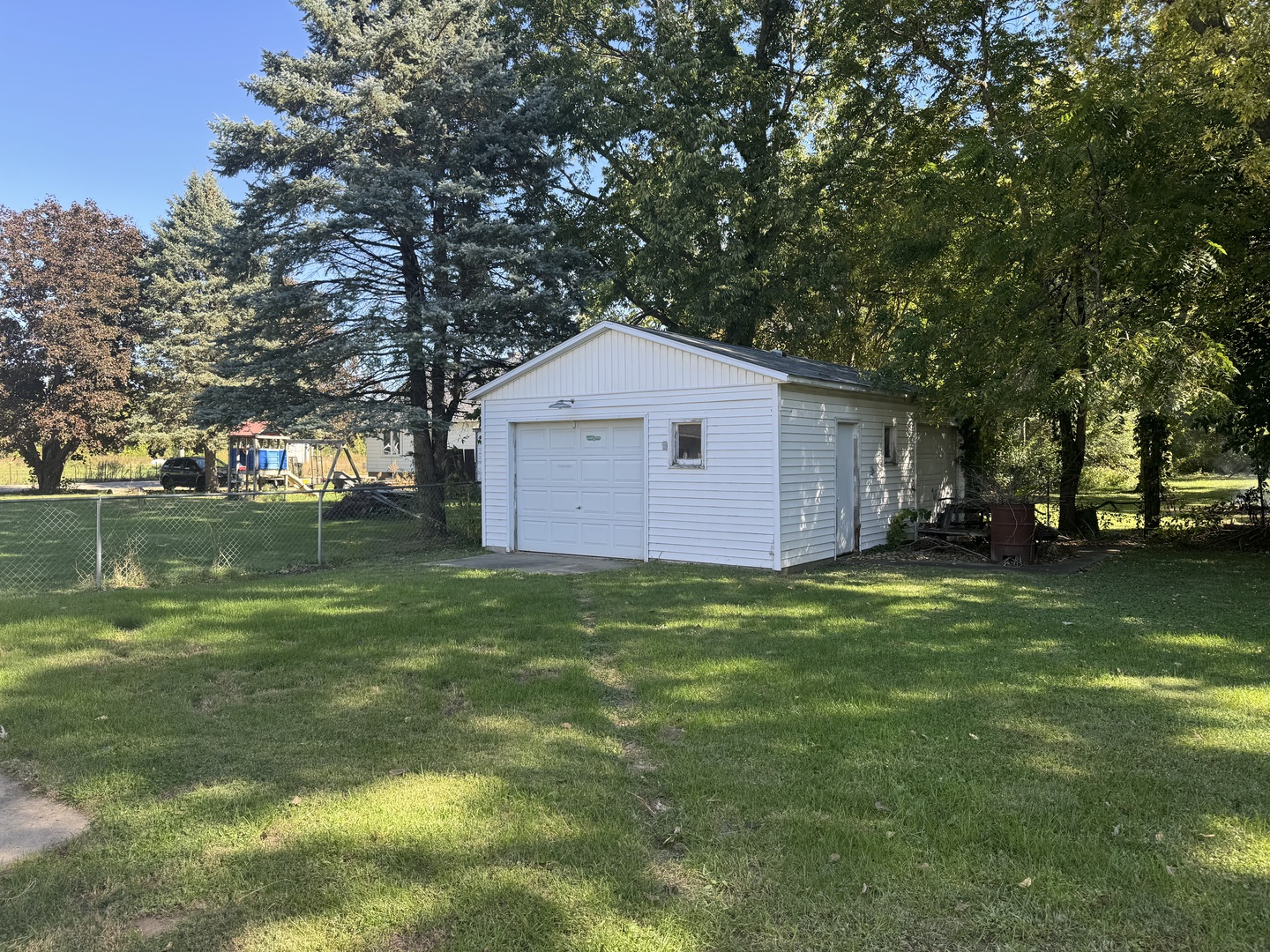 106 Main Street Nelson, IL 61021 - Photo 4 of 17 a backyard of a house with lots of green space and lake view