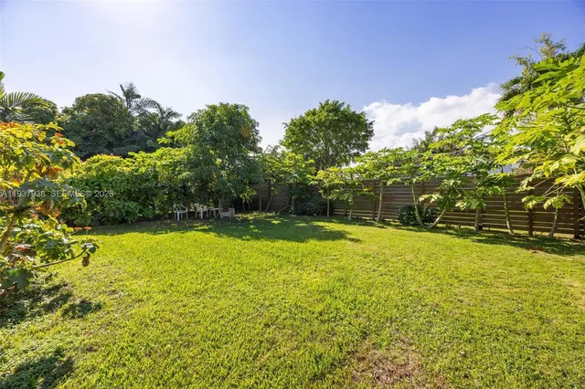 a view of a swimming pool with an outdoor space and seating area