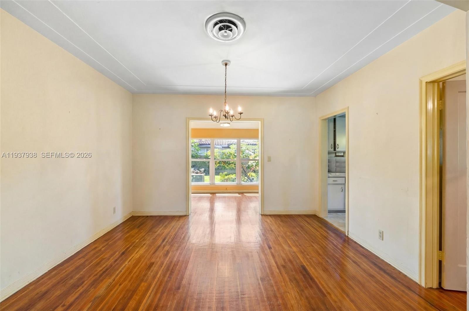 9148 Abbott Avenue Surfside, FL 33154 - Photo 14 of 39 a view of an empty room with wooden floor and a window
