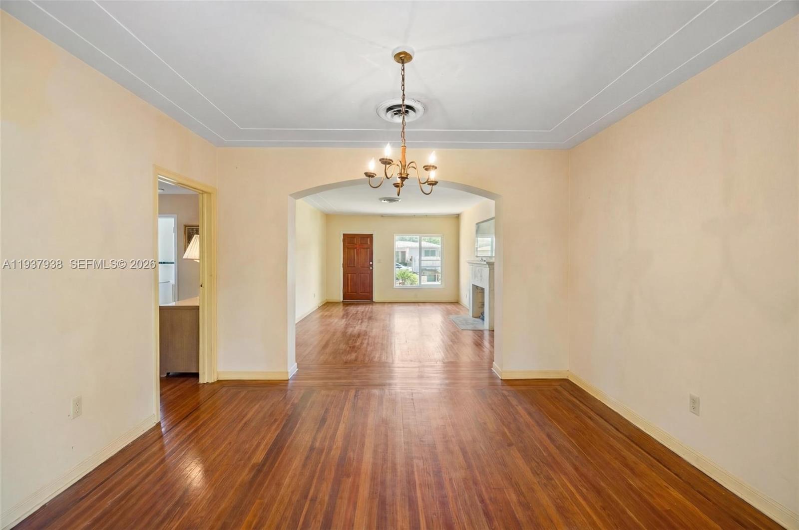 9148 Abbott Avenue Surfside, FL 33154 - Photo 15 of 39 a view of a hallway with wooden floor and a chandelier