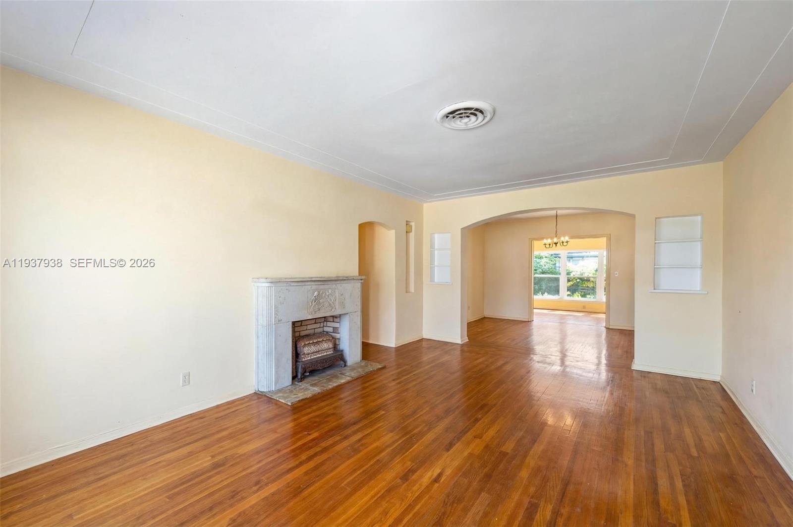 9148 Abbott Avenue Surfside, FL 33154 - Photo 16 of 39 a view of empty room with wooden floor and fireplace
