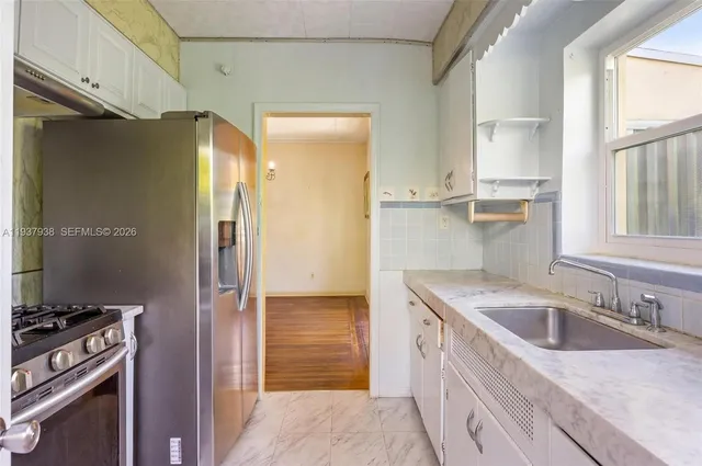 a kitchen with a sink stove and refrigerator