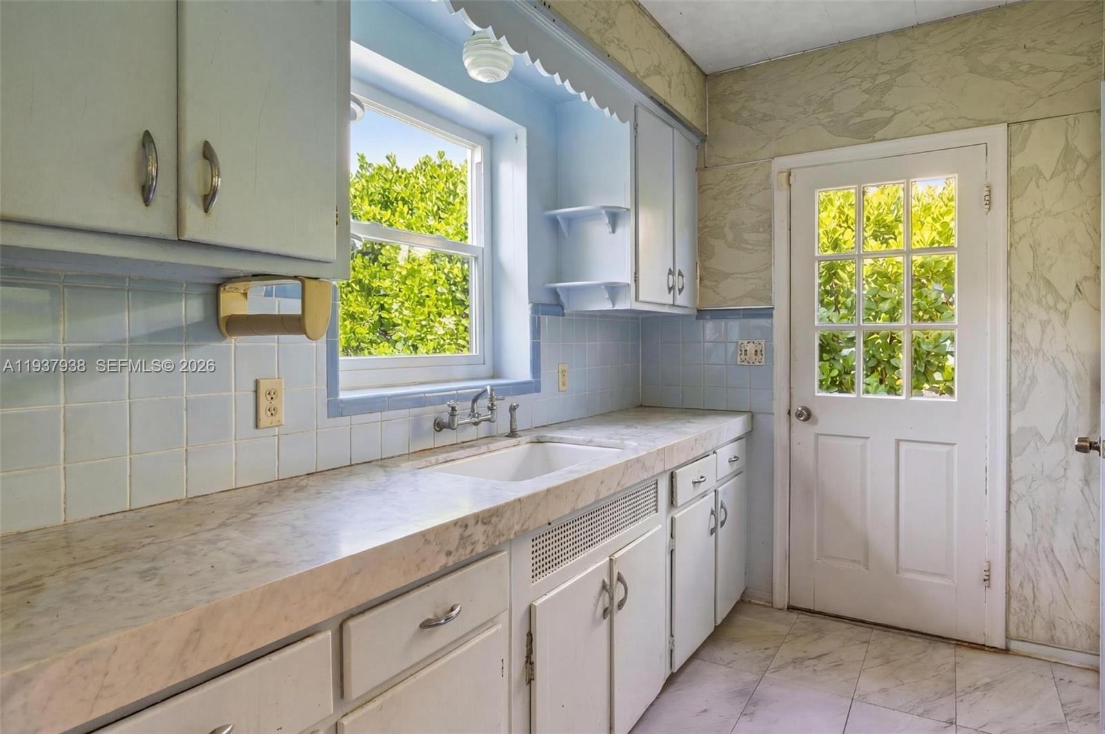 9148 Abbott Avenue Surfside, FL 33154 - Photo 23 of 39 a kitchen with a sink and a window
